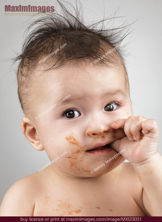 Stock photo of One Messy Baby Boy Sucking His Thumb Buy commercial use license at MaximImages