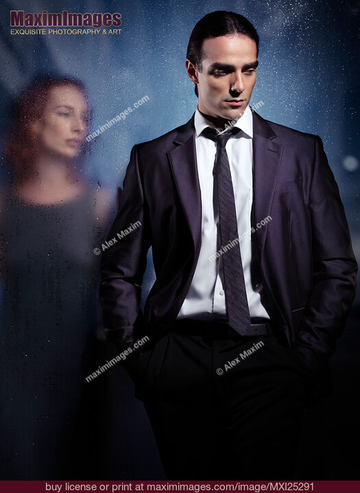 Stock photo of Emotional portrait of a couple separated with glass Buy commercial use license at MaximImages