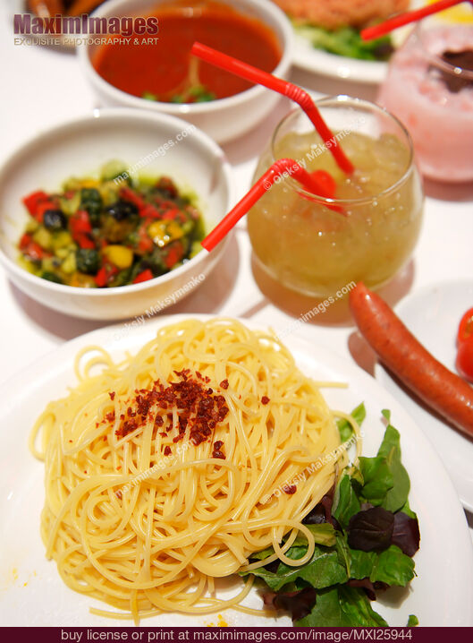 Stock photo of Pasta lunch on cafe table Buy commercial use license at MaximImages
