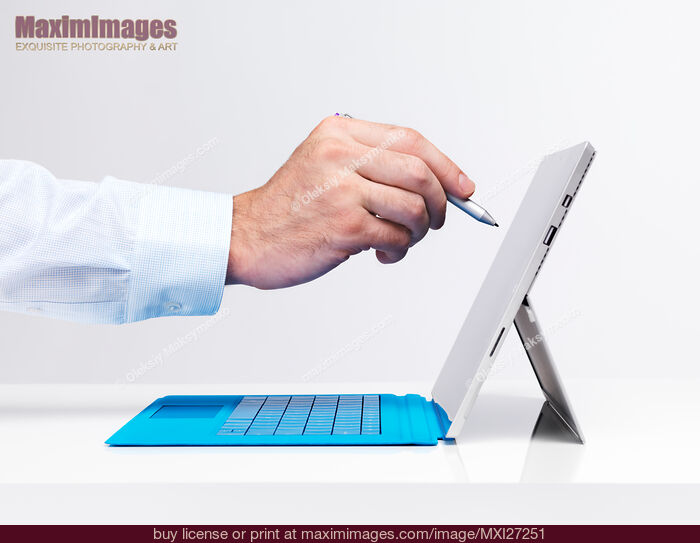 Stock photo of Hand with a pen touching display of Microsoft tablet Surface Pro 3 Buy commercial use license at MaximImages