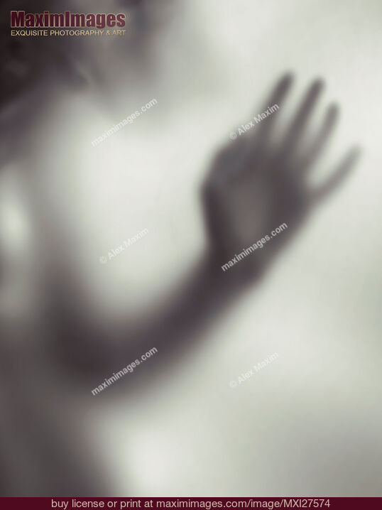 Stock photo of Woman blurred hand behind glass Buy commercial use license at MaximImages