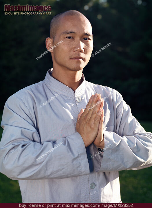 Stock photo of Portrait of a Shaolin warrior monk with folded hands Buy commercial use license at MaximImages