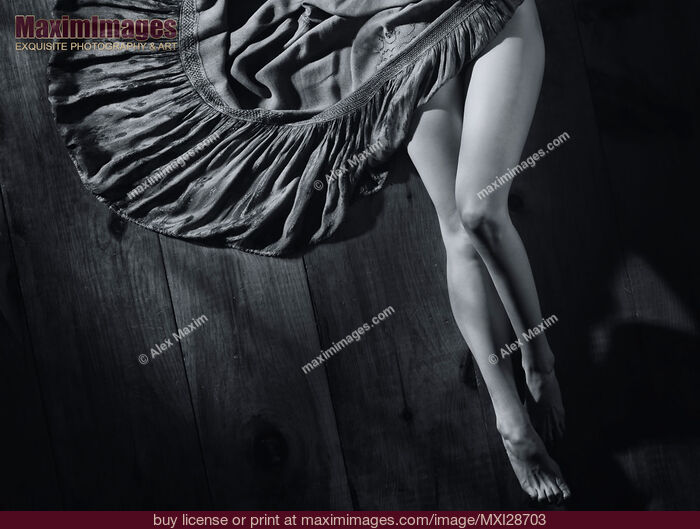 Stock photo of Sexy woman legs and green dress on wooden floor Black and white Buy commercial use license at MaximImages