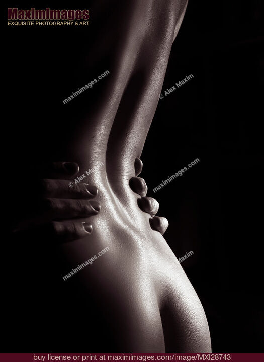 Stock photo of Artistic nude photo of woman body with man hands on her waist Buy commercial use license at MaximImages