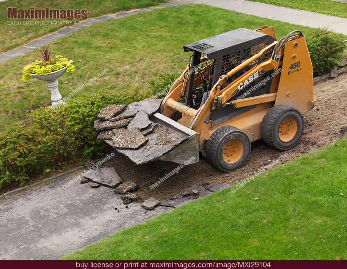 Skid Steer Loader Removing Pavement. Stock Photo MXI29104