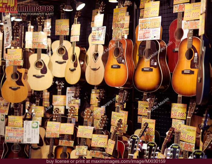 Acoustic guitars on display in a Japanese music instrument store. Stock Photo MXI30159