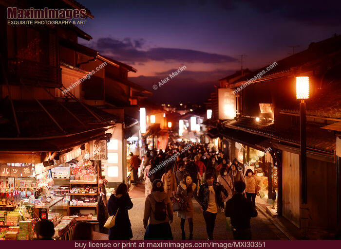 Stock photo of Matsubara dori street in Kyoto at night with brightly lit souvenir shops and street lights busy with tourists Buy commercial use license at MaximImages