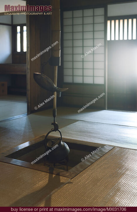 Stock photo of Irori Japanese traditional sunken hearth fire pit with a kettle Kama and a fish shaped lever Buy commercial use license at MaximImages