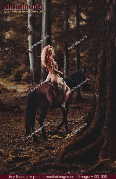 Stock photo of Half-naked young woman riding a horse in the forest Buy commercial use license at MaximImages