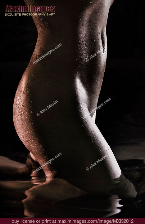 Stock photo of Sexy nude woman body parts wet dark shiny skin in water midsection closeup Buy commercial use license at MaximImages