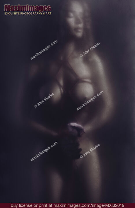 Stock photo of Surreal art nude beautiful nude woman with a rose tied with shibari rope bondage behind a hazy glass black and white Buy commercial use license at MaximImages