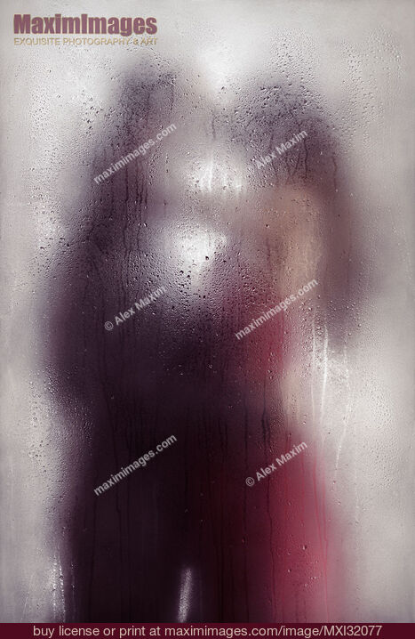 Stock photo of Sensual couple kissing standing behind wet glass in an embrace Dreamy abstract fine art concept Buy commercial use license at MaximImages