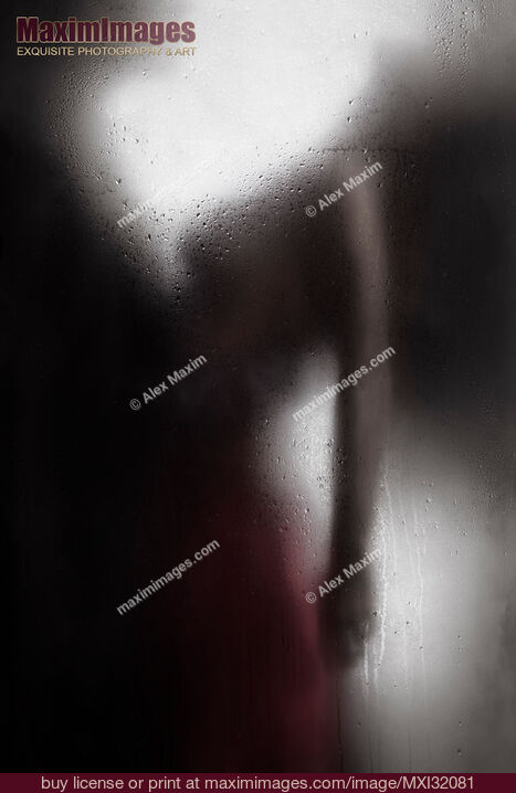 Stock photo of Sensual couple behind wet glass man holding a woman by the waist Buy commercial use license at MaximImages