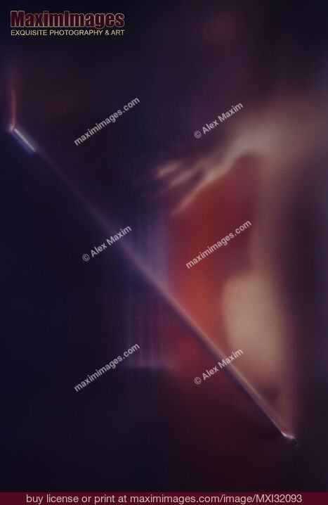 Stock photo of Mysterious romantic concept of a woman playing cello in dark dream-like haze behind blurry glass Buy commercial use license at MaximImages