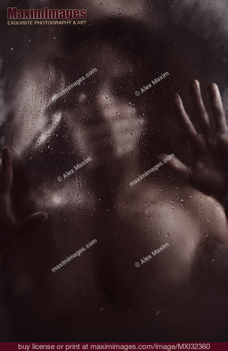 Stock photo of Man hand covering woman mouth silencing or suffocating her behind wet blurry glass in dark Buy commercial use license at MaximImages