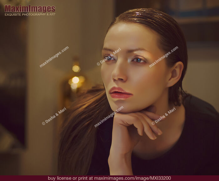 Stock photo of Cinematic style portrait of a beautiful woman face with a pensive look with luxurious high-end styling Buy commercial use license at MaximImages