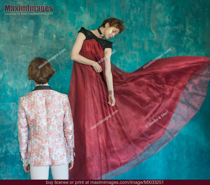 Stock photo of Romantic magician couple, a man and a woman is levitating in beautiful red dress Buy commercial use license at MaximImages