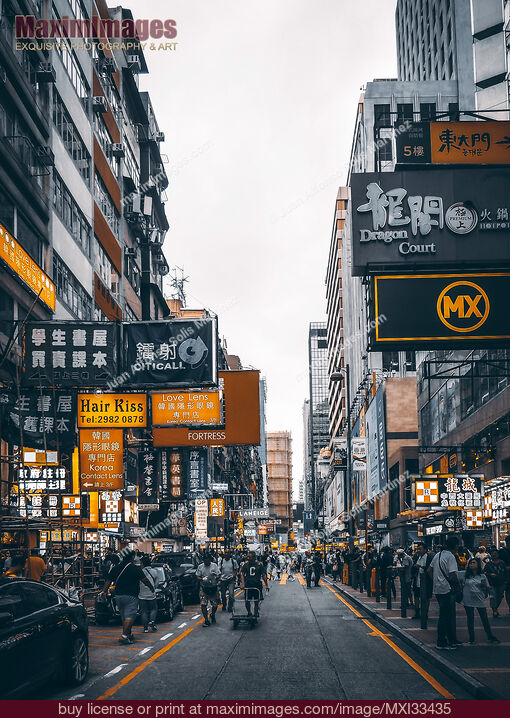 Stock photo of Busy streets of Hong Kong China full of people and shop signs Buy commercial use license at MaximImages