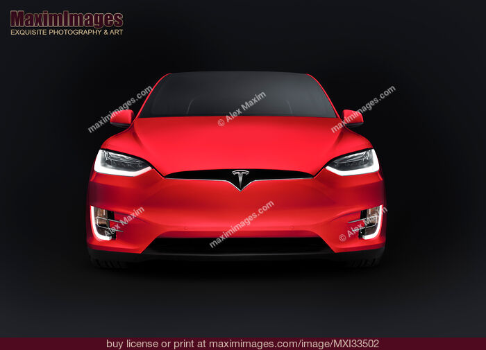 Stock photo of Red Tesla Model X luxury SUV electric car front view isolated on black Buy commercial use license at MaximImages