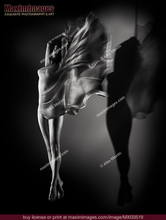 Stock photo of Beautiful half-naked woman with wing-like cloth wrapped around her nude body and her shadow suspended with bondage ropes Buy commercial use license at MaximImages
