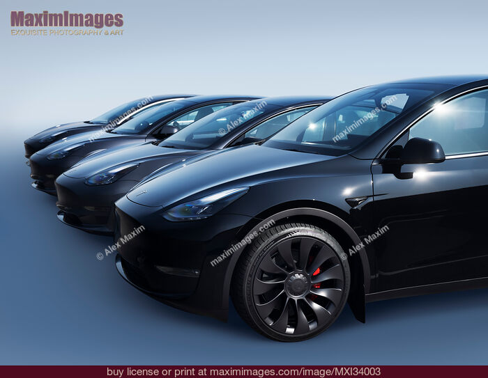 Stock photo of Black Tesla Model Y and Tesla 3 electric cars in a row on blue background Buy commercial use license at MaximImages