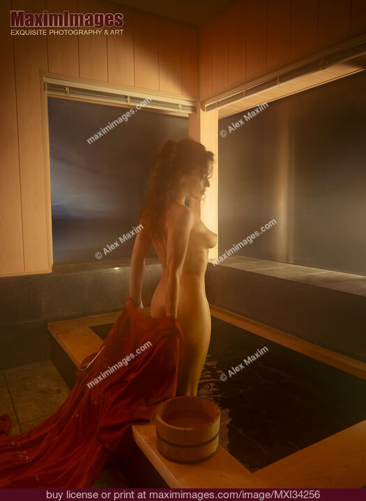 Stock photo of Young nude woman undressing entering naked into a steamy indoor onsen bath tub Buy commercial use license at MaximImages