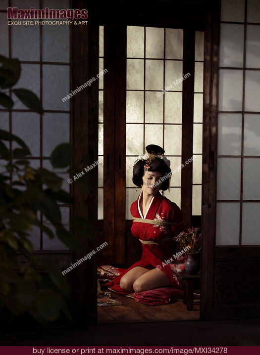 Stock photo of Beautiful caucasian lady, Japanese geisha in red kimono sitting tied up with Shibari bondage ropes Buy commercial use license at MaximImages