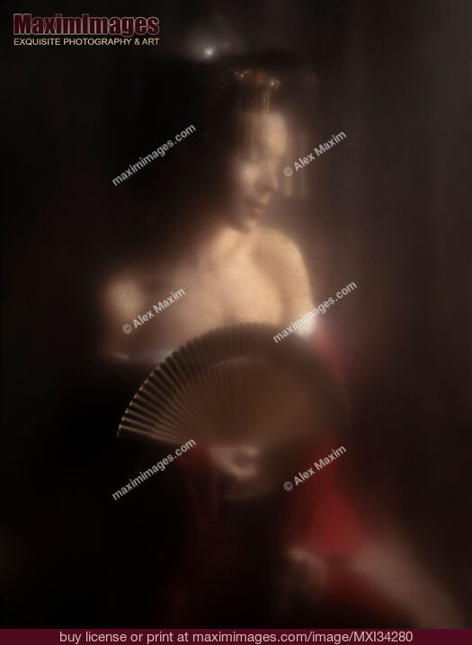 Stock photo of Sensual portrait of beautiful Japanese geisha or courtesan with bared shoulders and a hand fan behind glass Buy commercial use license at MaximImages