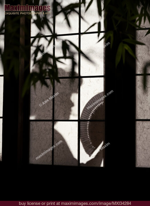 Stock photo of Shadow of a Japanese geisha with a hand fan behind shoji screen of traditional Japanese house at night Buy commercial use license at MaximImages