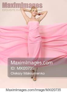 Beautiful Young Woman in Pink Flowy Fabric Dress... preview image