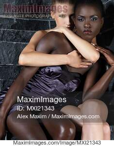 Two beautiful young women, african and caucasian, black and...... preview image