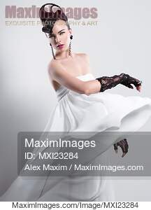 Beautiful Woman with a Creative Hairstyle Wearing a Long White Dress... preview image