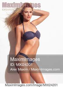 Young woman wearing gray two-piece bikini swimsuit... preview image