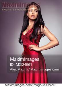 Young black woman wearing red dress... preview image