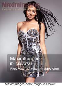 Smiling young woman wearing fancy shiny dress... preview image