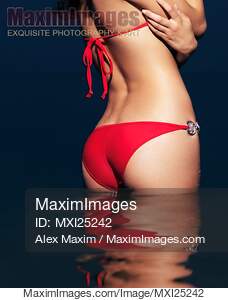 Sexy woman bottom in red bikini in water... preview image