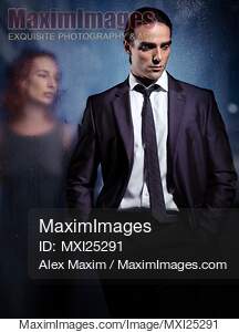 Emotional portrait of a couple separated with glass... preview image