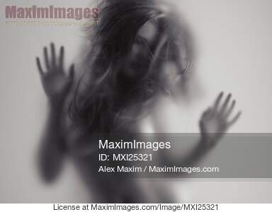 Beautiful young woman behind glass... preview image