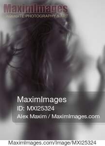 Young woman trapped behind glass... preview image