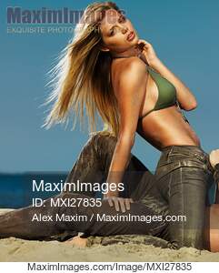 Sensual portrait of sexy young woman and a man on a sandy beach... preview image