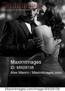 Beautiful portrait of couple standing near window on rainy...... preview image