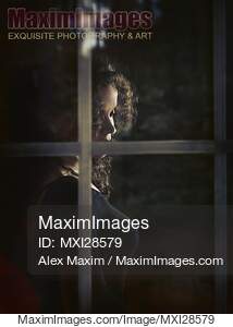 Woman face behind window glass... preview image