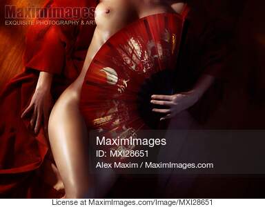 Beautiful naked woman body covered with red Asian fan... preview image