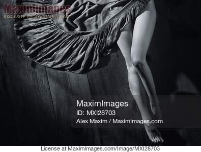 Sexy woman legs and green dress on wooden floor Black and white... preview image