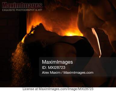 Sensual dynamic photo of couple making love in front of fireplace... preview image