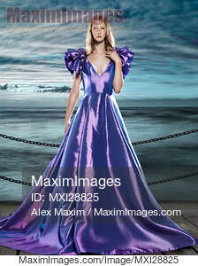 Woman wearing beautiful long blue dress at waterfront... preview image