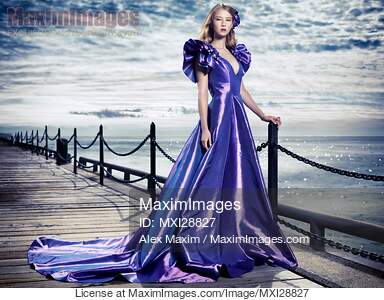 Young woman in beautiful long evening gown at waterfront... preview image