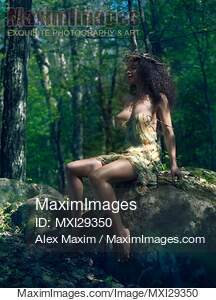 Beautiful woman in a sexy revealing dress in a forest erotic portrait... preview image