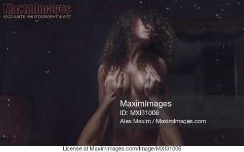 Couple making love behind a wet window with rain drops on...... preview image