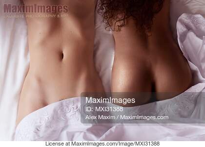 Two sexy girls interracial lesbian couple lying together in...... preview image